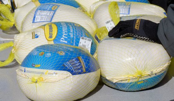 Members of the Vegas Golden Knights place turkeys on a table to distribute to families in need in Las Vegas, Nevada, on Nov. 23, 2020.