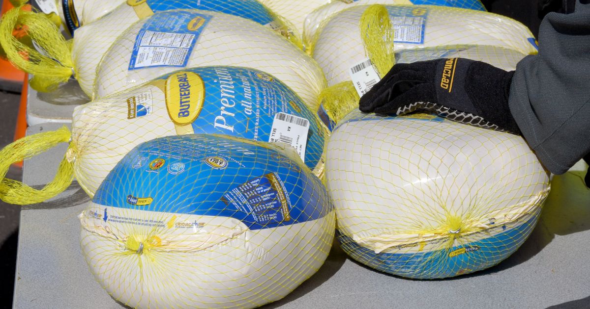 Members of the Vegas Golden Knights place turkeys on a table to distribute to families in need in Las Vegas, Nevada, on Nov. 23, 2020.