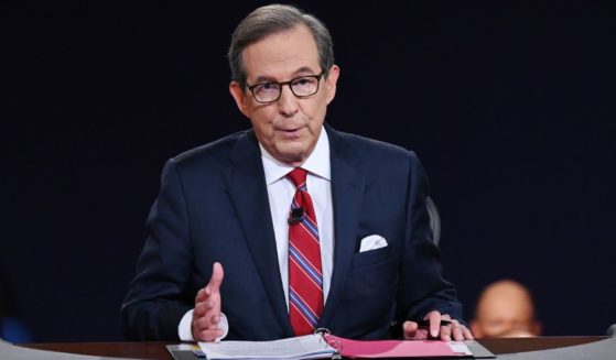 Debate moderator and then-Fox News anchor Chris Wallace directs the first presidential debate between then-President Donald Trump and then-Democratic presidential nominee Joe Biden in Cleveland, Ohio, on Sept. 29, 2022.