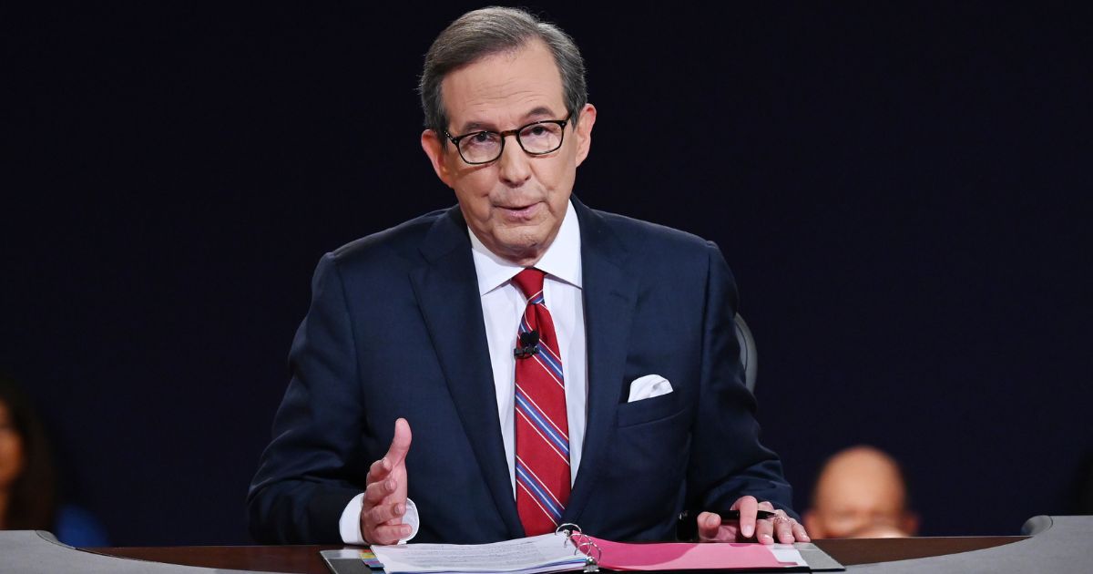 Debate moderator and then-Fox News anchor Chris Wallace directs the first presidential debate between then-President Donald Trump and then-Democratic presidential nominee Joe Biden in Cleveland, Ohio, on Sept. 29, 2022.