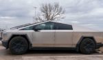 Newly manufactured Tesla Cybertrucks are parked outside the company's Giga Texas factory in Austin, Texas, on Dec. 13, 2023.