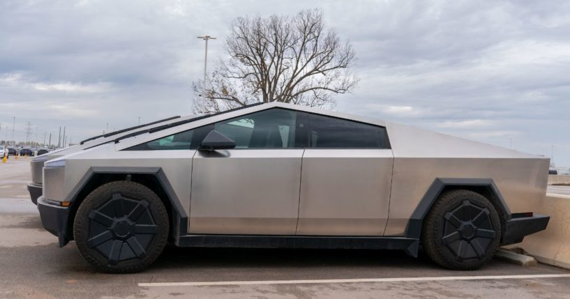 Newly manufactured Tesla Cybertrucks are parked outside the company's Giga Texas factory in Austin, Texas, on Dec. 13, 2023.