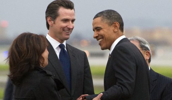 Then-President Barack Obama, right, greets then-California Lt. Gov. Gavin Newsom, middle, and then-California Attorney General, left, after arriving on Air Force One at San Francisco International Airport in San Francisco, California, on Feb. 17, 2011.