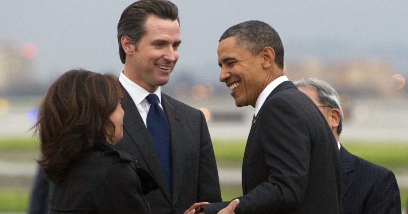 Then-President Barack Obama, right, greets then-California Lt. Gov. Gavin Newsom, middle, and then-California Attorney General, left, after arriving on Air Force One at San Francisco International Airport in San Francisco, California, on Feb. 17, 2011.