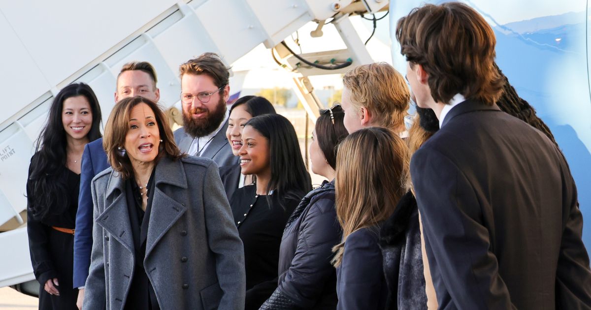 Vice President Kamala Harris talks to her campaign staff in front of Air Force Two as she prepares to depart from Harry Reid International Airport in Las Vegas, Nevada, on Friday.