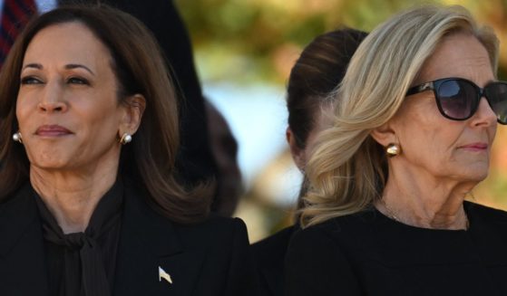 Vice President Kamala Harris, left, and first lady Jill Biden, right, listen to President Joe Biden deliver remarks at the National Veterans Day Observance at Arlington National Cemetery in Arlington, Virginia, on Monday.