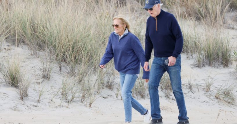 President Joe Biden, right, and first lady Jill Biden, left, walk on the beach at Gordons Pond in Rehoboth Beach, Delaware, on Sunday.