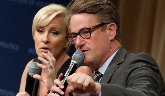 Joe Scarborough, right, and Mika Brzezinski, left, are interviewed by philanthropist and financier David Rubenstein during a Harvard Kennedy School Institute of Politics event in Washington, D.C., on July 12, 2017.