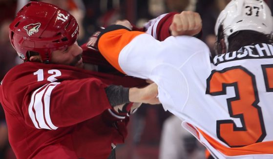 Paul Bissonnette of the Phoenix Coyotes, left, fights with Jay Rosehill of the Philadelphia Flyers, right, during the second period of the NHL game in Glendale, Arizona, on Jan. 4, 2014.