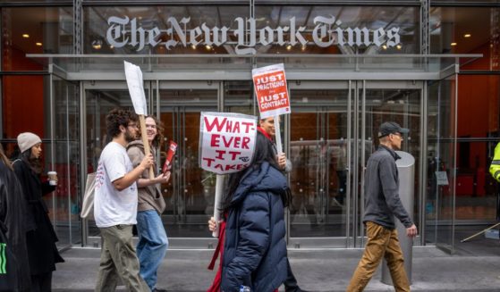 Members of The New York Times Tech Guild protest outside of the New York Times headquarters building in New York City on Monday.