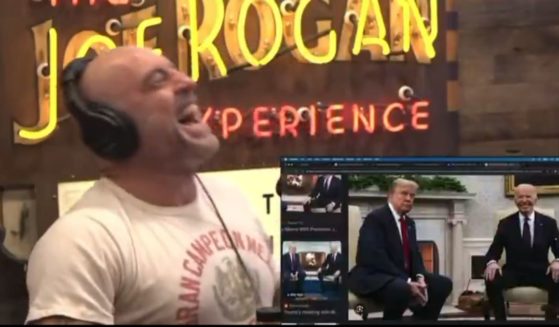 Podcaster Joe Rogan laughing at the expression on President Joe Biden's face while meeting President-elect Donald Trump in 2024.