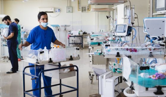 A nurse checks the health of newborn babies in the neonatal intensive care unit at Rajnidera hospital on April 11, 2023 in Patiala, India.