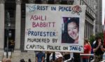 A right wing protester holds a sign about Ashli Babbitt while participating in a political rally on July 25, 2021 in New York City. Protesters were demanding a release of the people who were arrested on January 6th for their involvement in the breach of the Capitol building.