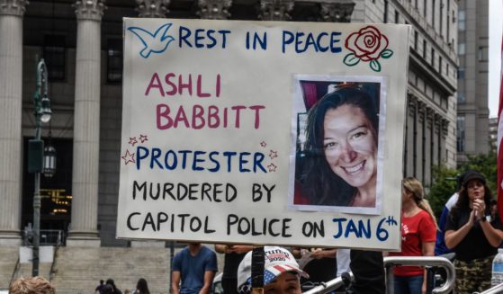 A right wing protester holds a sign about Ashli Babbitt while participating in a political rally on July 25, 2021 in New York City. Protesters were demanding a release of the people who were arrested on January 6th for their involvement in the breach of the Capitol building.