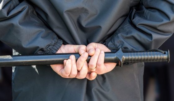 Stock image of a policeman holding a baton.