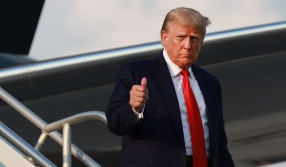 Former U.S. President Donald Trump gives a thumbs up as he arrives at Atlanta Hartsfield-Jackson International Airport on August 24, 2023 in Atlanta, Georgia.