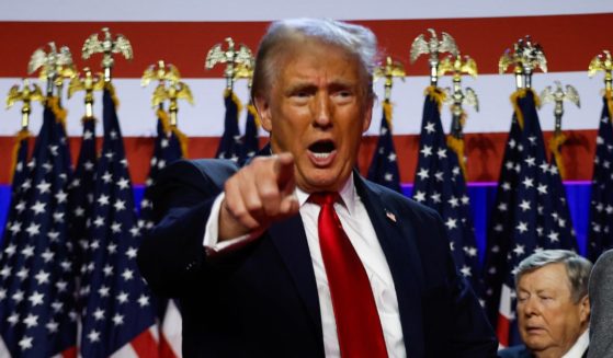 Republican presidential nominee, former U.S. President Donald Trump points to supporters with former first lady Melania Trump during an election night event at the Palm Beach Convention Center on November 06, 2024 in West Palm Beach, Florida.