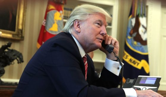 U.S. President Donald Trump speaks on the phone in the Oval Office of the White House June 27, 2017 in Washington, DC.