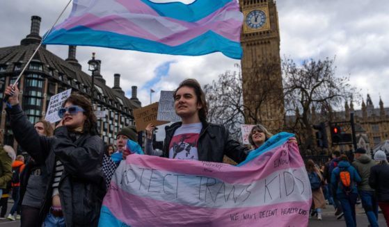 Trans rights activists take part in a protest against the ban on hormone blockers in London, England, on April 20.