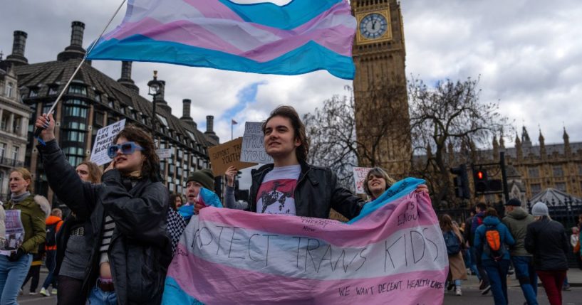 Trans rights activists take part in a protest against the ban on hormone blockers in London, England, on April 20.