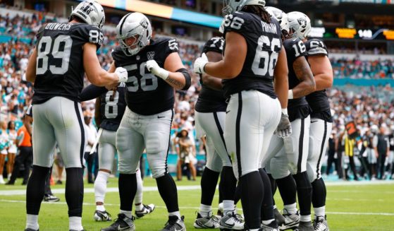 Brock Bowers, left, of the Las Vegas Raiders celebrates a touchdown by performing the "Trump Dance" with fellow teammates.