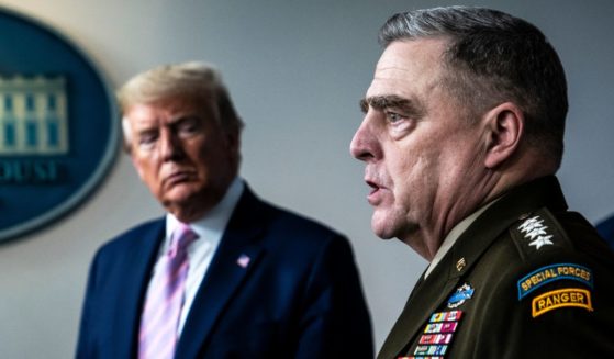 Then-President Donald J. Trump listens to then-Chairman of the Joint Chiefs Gen. Mark Milley during a briefing at the White House in response to the COVID-19 on April 1, 2020.