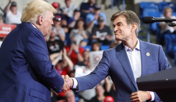 Dr. Mehmet Oz, right, is greeted by former president Donald Trump, left, at a rally in Wilkes-Barre, Pennsylvania, on Sept. 3, 2022.