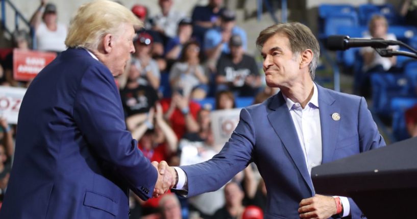 Dr. Mehmet Oz, right, is greeted by former president Donald Trump, left, at a rally in Wilkes-Barre, Pennsylvania, on Sept. 3, 2022.