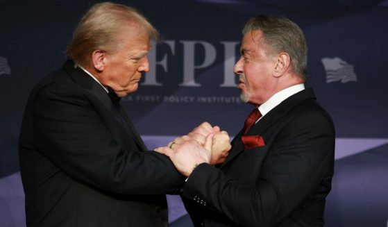 President-elect Donald Trump, left, greets actor Sylvester Stallone, right, onstage at the America First Policy Institute Gala in Palm Beach, Florida, on Thursday.