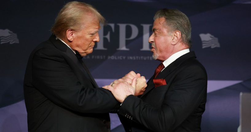 President-elect Donald Trump, left, greets actor Sylvester Stallone, right, onstage at the America First Policy Institute Gala in Palm Beach, Florida, on Thursday.