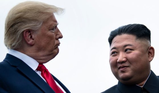 Then-President Donald Trump and North Korea's leader Kim Jong-un talk before a meeting in the Demilitarized Zone on June 30, 2019, in Panmunjom, Korea.