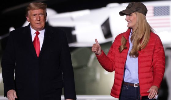 Then-President Donald Trump arrives with then-Sen. Kelly Loeffler, a Georgia Republican, at a campaign rally in Dalton, Georgia, in a file photo from Jan. 4, 2021.