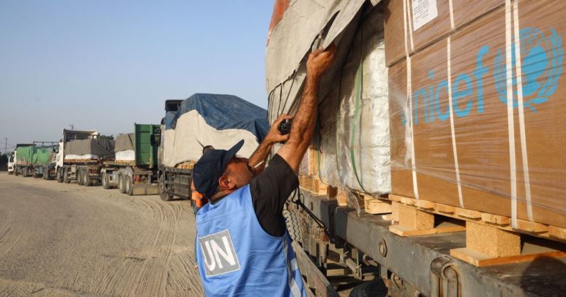 A United Nations employee checks humanitarian aid on a convoy of lorries entering the Gaza Strip from Egypt via the Rafah border crossing in a file photo from Oct. 21, 2023. The United Nations Relief and Works Agency complained this week that one such convoy was "violently looted" while passing through Gaza.