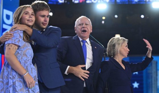 Gov. Tim Walz, second from right, stands with wife Gwen Walz, right, and children Gus Walz, second from left, and Hope Walz, left, after speaking on the third day of the Democratic National Convention in Chicago, Illinois, on Aug. 20.