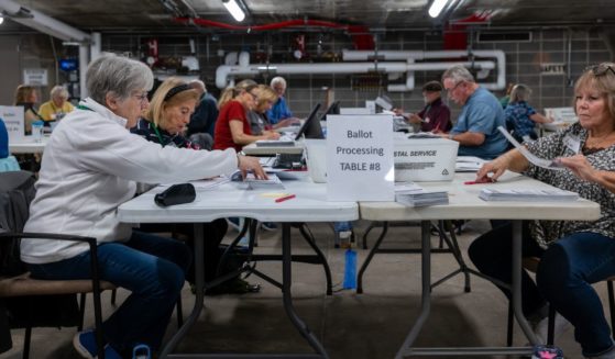 Poll workers process ballots at City Hall in Janesville, Wisconsin, on Tuesday.