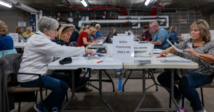 Poll workers process ballots at City Hall in Janesville, Wisconsin, on Tuesday.