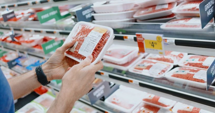 This Getty stock image shows a customer handling a package of ground beef at the supermarket.