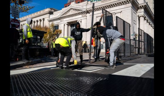 Workers erect anti-scale fencing around the White House and the Treasury Department along 15th St NW on November 3, 2024 in Washington, DC.