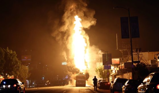 A Metro bus bus burns following Dodger fan celebrations in the area in Echo Park after the Los Angeles Dodgers defeated the New York Yankees in Game 5 to win the World Series on October 31, 2024 in Los Angeles, California.