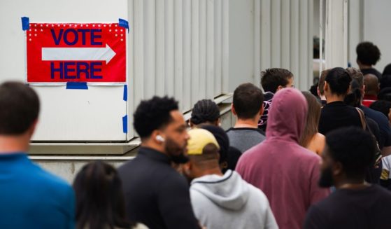 Voters head into a polling location to cast their ballots on the last day of early voting for the 2024 election on November 1, 2024 in Atlanta, Georgia.