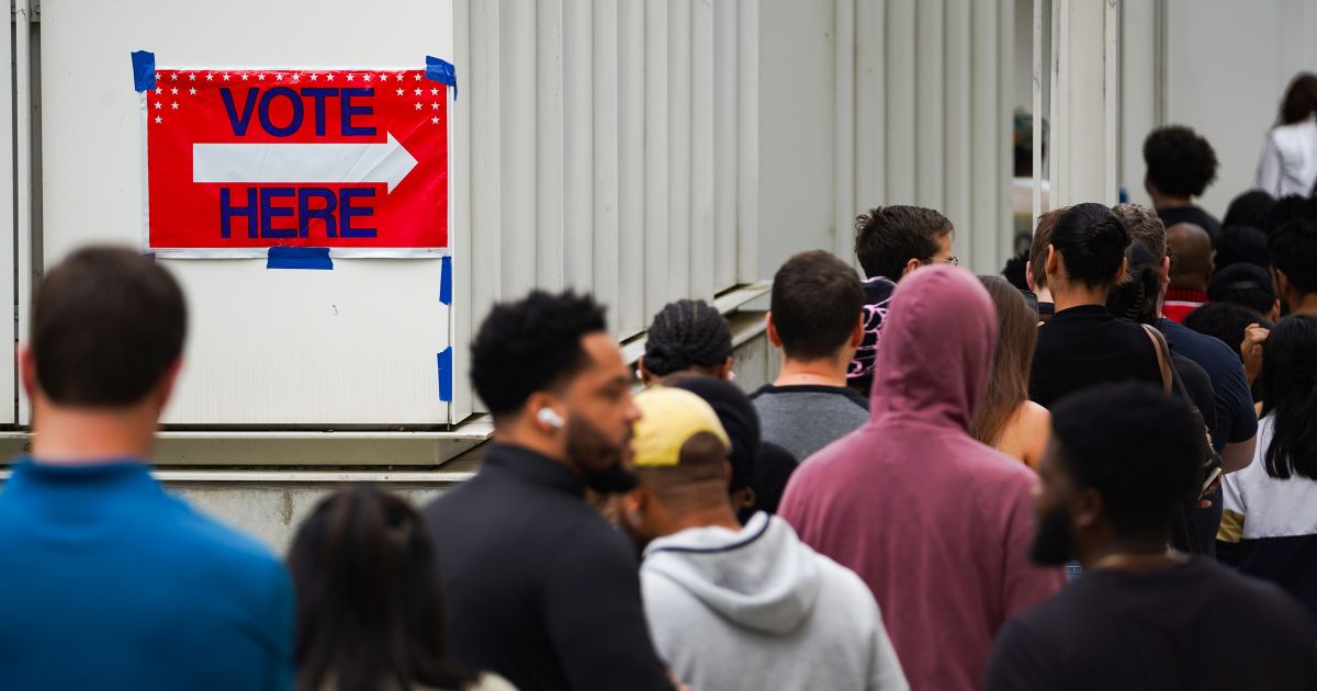 Voters head into a polling location to cast their ballots on the last day of early voting for the 2024 election on November 1, 2024 in Atlanta, Georgia.