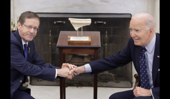 President Isaac Herzog (L) of Israel presents to U.S. President Joe Biden (R) with an artifact from the foot of Temple Mount in Jerusalem that has the word "Joseph" on it during a meeting in the Oval Office of the White House on November 12, 2024 in Washington, DC.