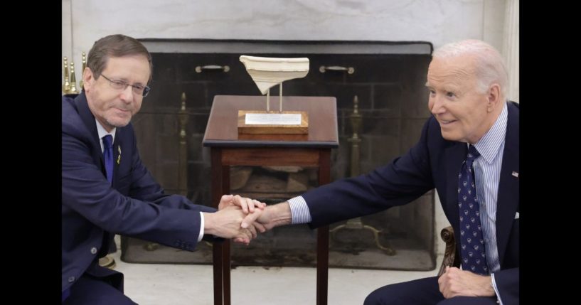 President Isaac Herzog (L) of Israel presents to U.S. President Joe Biden (R) with an artifact from the foot of Temple Mount in Jerusalem that has the word "Joseph" on it during a meeting in the Oval Office of the White House on November 12, 2024 in Washington, DC.