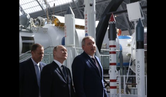 Russians President Vladimir Putin (C), Deputy Prime Minister Dmitry Rogozin (R) and Roscosmos Head Igor Komarov (L) observe the exposition of missiles at the Cosmos pavillion space industry exhibiton on April 12, 2018 in Moscow, Russia.