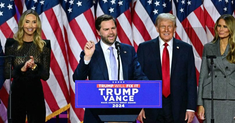 US Senator from Ohio and Republican vice presidential candidate J.D. Vance (C) speaks alongside former US President and Republican presidential candidate Donald Trump during an election night event at the West Palm Beach Convention Center in West Palm Beach, Florida, on November 6, 2024.