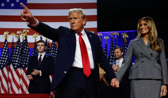 Republican presidential nominee, former U.S. President Donald Trump points to supporters with former first lady Melania Trump during an election night event at the Palm Beach Convention Center on November 6, 2024 in West Palm Beach, Florida.