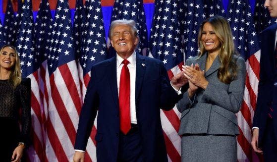 Republican presidential nominee, former U.S. President Donald Trump reacts on stage with former first lady Melania Trump during an election night event at the Palm Beach Convention Center on November 6, 2024 in West Palm Beach, Florida.