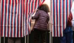 People enter voting booths at a polling station at Colebrook Academy and Elementary School in Colebrook, New Hampshire, on Election Day, November 5, 2024.