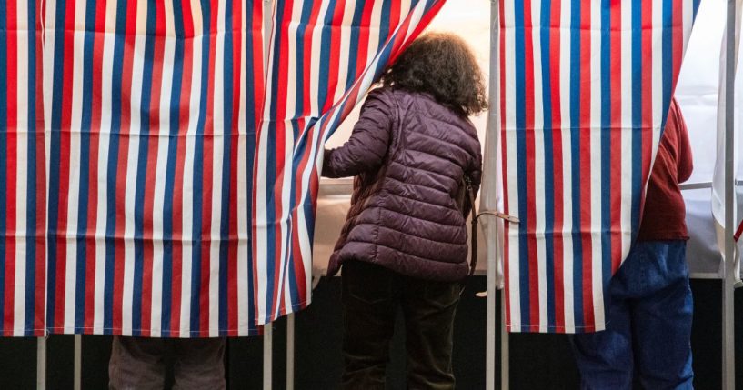 People enter voting booths at a polling station at Colebrook Academy and Elementary School in Colebrook, New Hampshire, on Election Day, November 5, 2024.