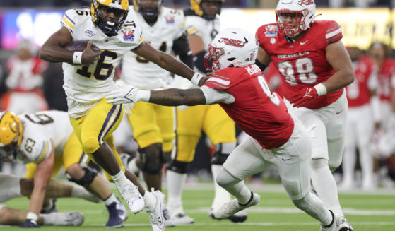 California quarterback CJ Harris, left, stiff arms UNLV linebacker Marsel McDuffie during the first half of the LA Bowl NCAA college football game in Inglewood, California, on Wednesday.